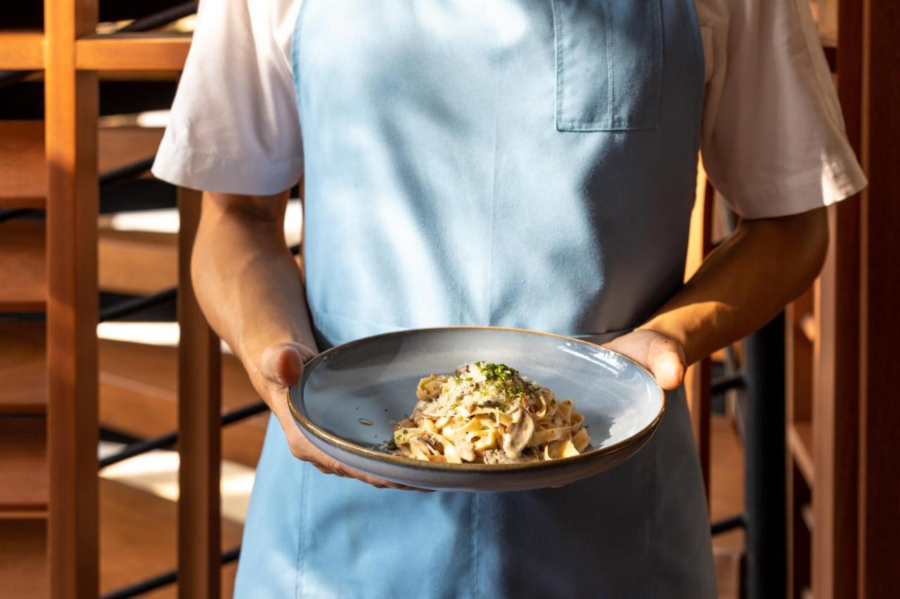 Outrigger Surin Beach Resort - Sha Extra Plus Екстериор снимка A server holding a plate of pasta