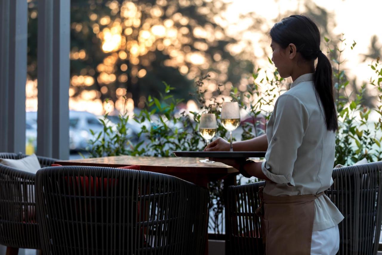 Outrigger Surin Beach Resort - Sha Extra Plus Екстериор снимка A waitress clearing a table